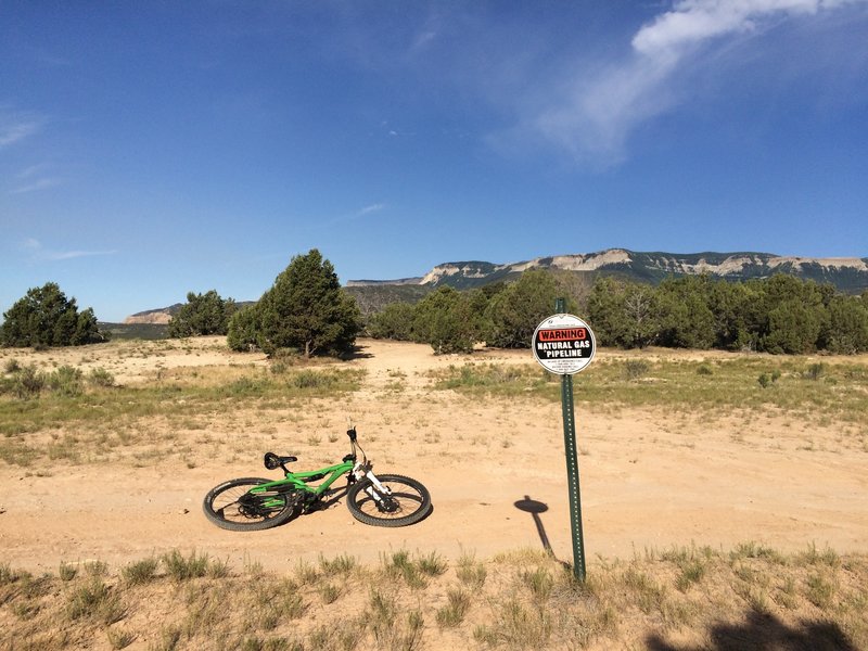 This marker shows the entrance to climbing to WTX.  Climb the jeep road that lies just beyond my bike.