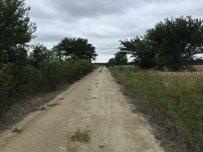 The trail will travel South of this point soon, the Nature Conservancy is working with land owners right now to complete it.