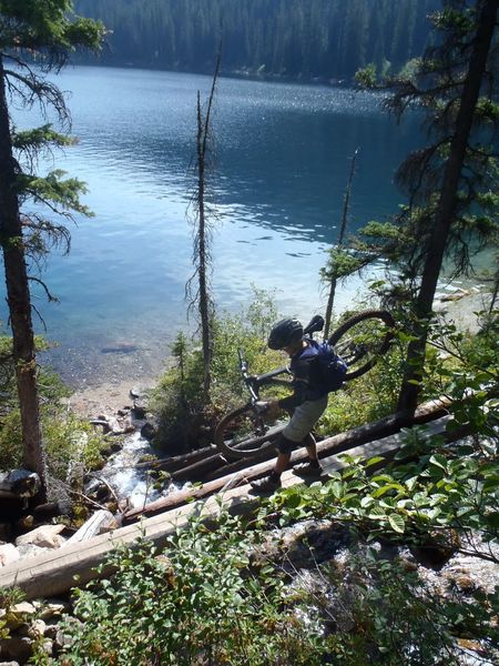 "Walking the plank" across a stream at the head of the lake.