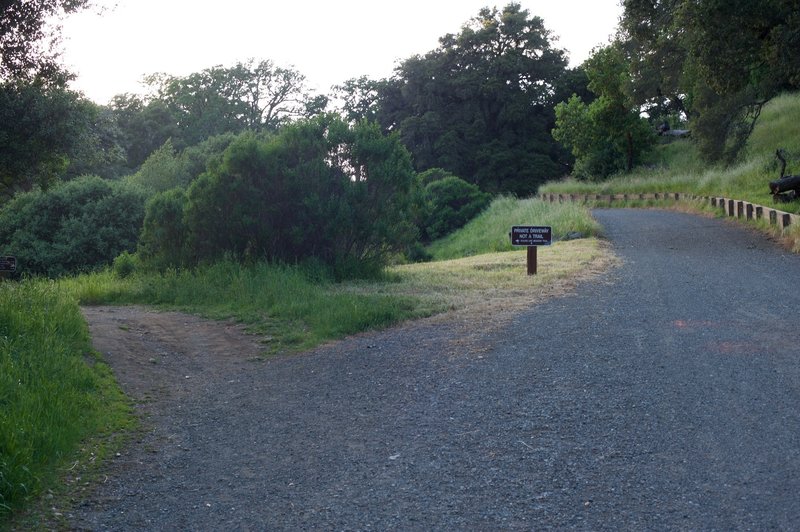 The Meadow Trail heads off to the left as the private drive continues straight ahead.