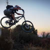 Dropping off the water tank at sunset, on the singletrack connector.