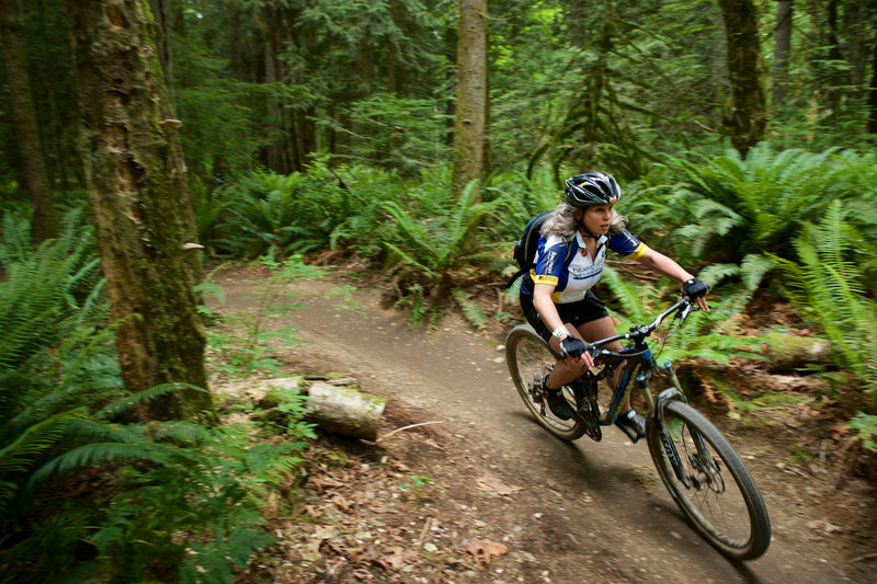 A rider enjoys the smooth berms found along Bootcamp at Duthie Bike Park, WA.