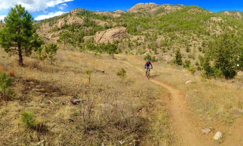 The infamous Beet Juice climbing the Herrington Trail with Horsetooth Rock in the background.