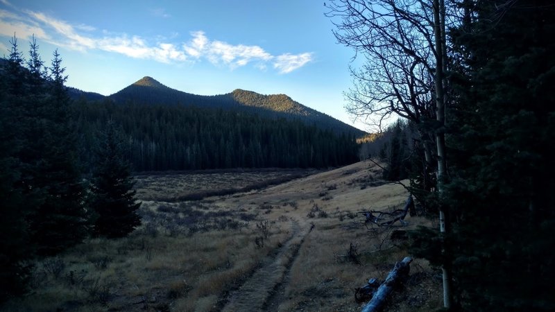 Early morning light on Horsethief Park Trail catches the top of the mountain which climbs to Pancake Rocks.