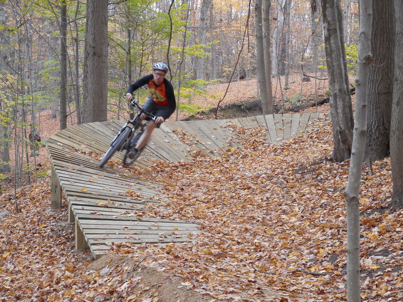 Berm feature on Hampton Hills Intermediate Trail heading downhill towards Woodward Creek.