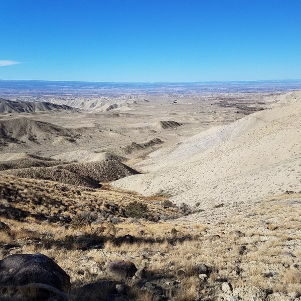 Looking out at the Adobes and Elephant Skin Road. The trail drops steeply down to the right.