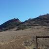 The turn to Elliot Mountain trail of the Outlaw Trail. Elliot mountain is in the distance.