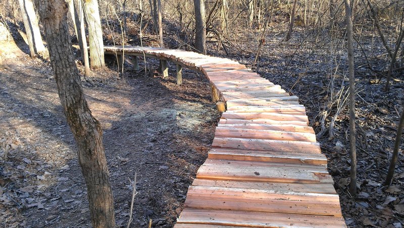 Elevated trail over low land that floods in the spring time.