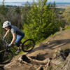 Emily rides the edge on the Ridge Trail, Galbraith Mountain, WA.