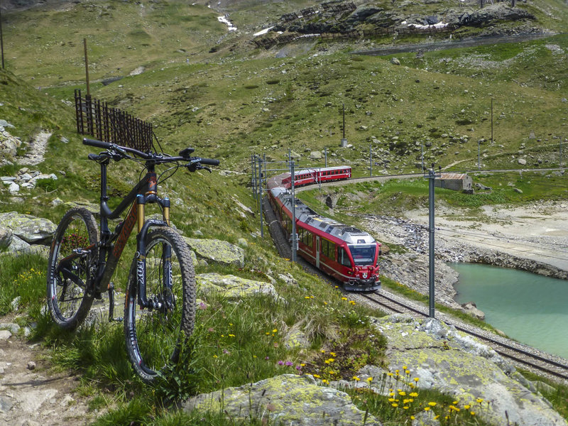 Singletrack paralleling the Bernina Express tracks through the Bernina Pass above Lago Bianco.  On the return trip, try to beat the train back to Samedan from the top of the pass starting from Ospizio Bernina station.