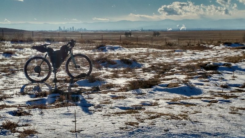 The Denver cityscape stands in the distance along the Rocky Mountain Arsenal Perimeter Trail.