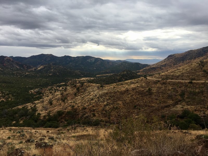 Looking west as the road winds its way through the mountains. The Chiricahua can be seen way off in the distance.