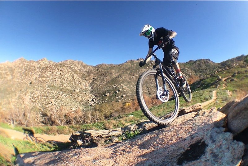 A rider floats through a rock patch on Two Trees Trail in Box Springs Mountain Reserve, CA.