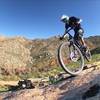 A rider floats through a rock patch on Two Trees Trail in Box Springs Mountain Reserve, CA.