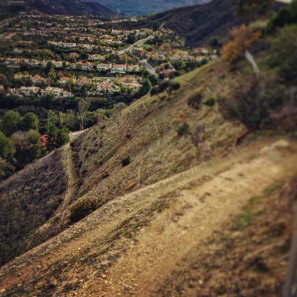 looking down off the switchbacks at the trail going around the mountain ...