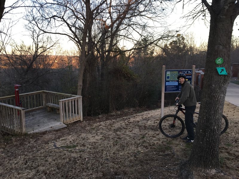 A bike fix-it station and track pump are conveniently located near the trail entry.