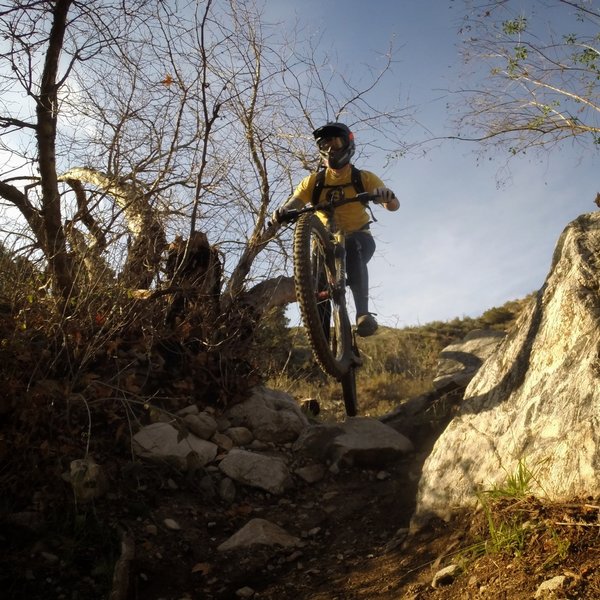 A rider airs a drop before a tight left-hander under the spillway.