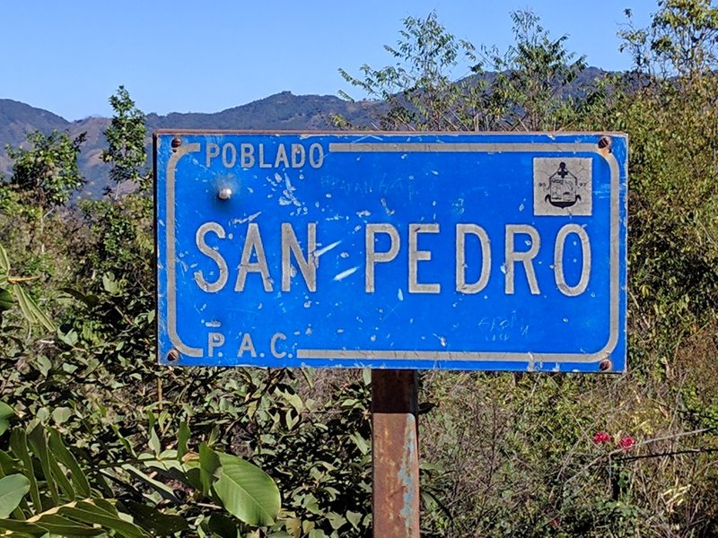 This hard-to-see little sign is all that indicates you've reached San Pedro. It is located about 150m beyond the restaurant at the summit.