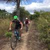 A pair of riders flies down the trail at La Leona.