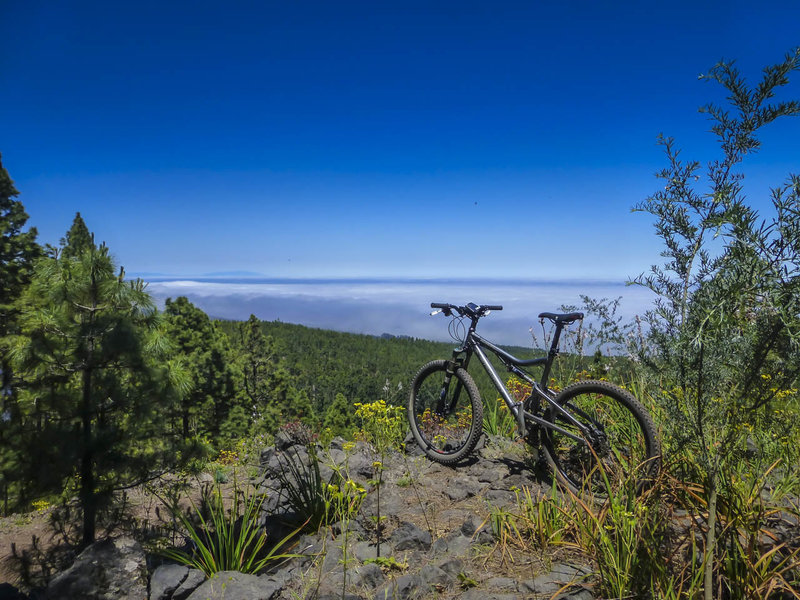 The clouds have erased the Atlantic Ocean a mile below, but you can still see the island of la Palma off in the distance.