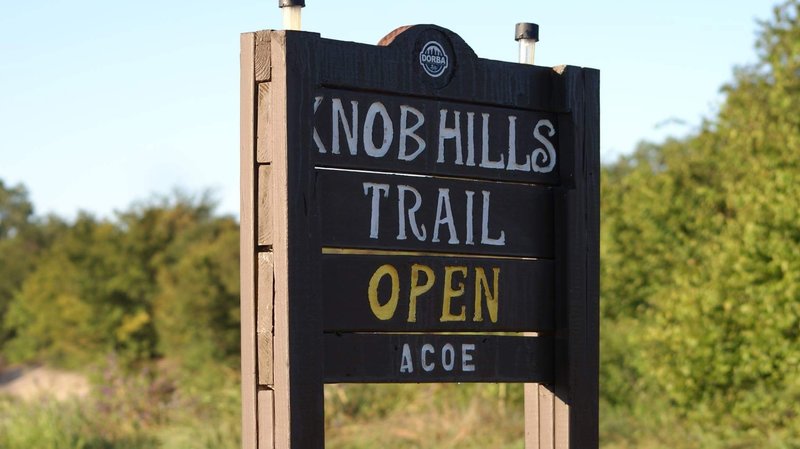 A trailhead sign notes whether or not the trails are open.