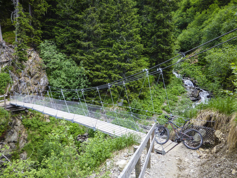 Get ready for a suspension bridge over Witibach Creek in the middle of the fun, forested singletrack section between Sertig and Clavadel.