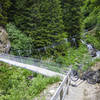 Get ready for a suspension bridge over Witibach Creek in the middle of the fun, forested singletrack section between Sertig and Clavadel.