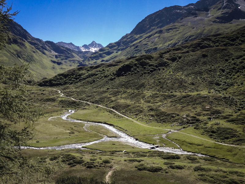 Enjoy the view of the Vereinatal Valley while savoring a meal and a beverage at the Berghaus Vereina - and dream where that road might lead.