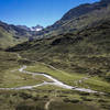 Enjoy the view of the Vereinatal Valley while savoring a meal and a beverage at the Berghaus Vereina - and dream where that road might lead.