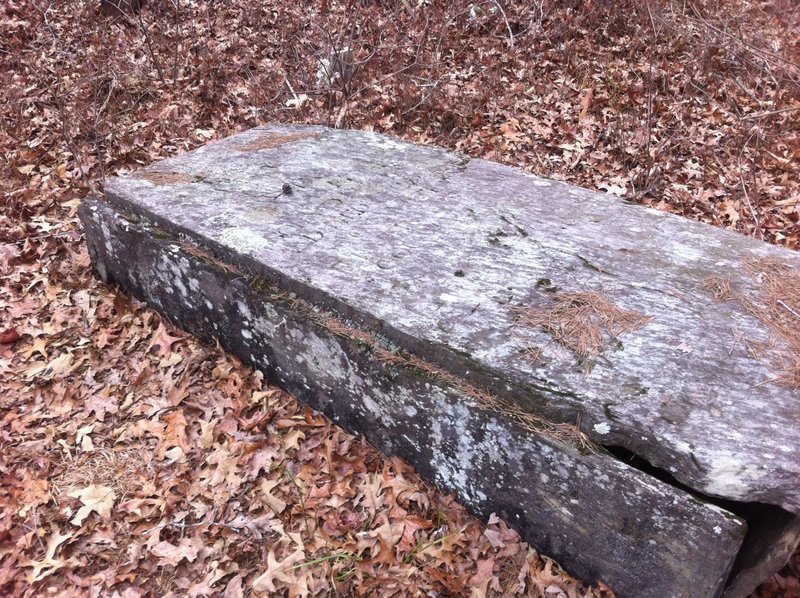 Ferabrew Grave lays weather worn in the graveyard.