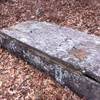 Ferabrew Grave lays weather worn in the graveyard.