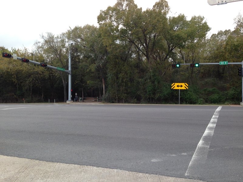 The entrance to Cullen Park Bike and Hike Trail is on the west side of SH 6, as viewed from the parking lot on the northeast corner of the intersection with Patterson Road.