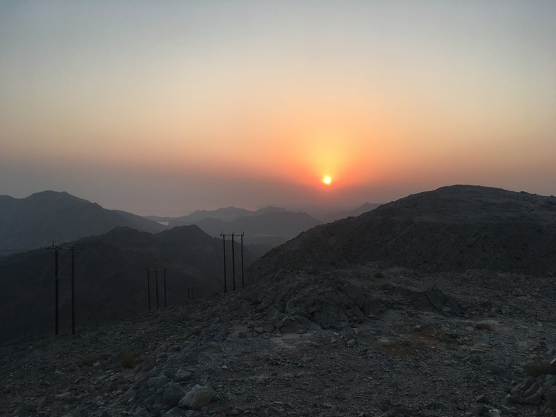 The sun rises over the far end of the trail at the turnaround.