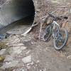 A drainage pipe crosses under Paper Mill Road. Ride on!