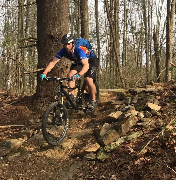 Erin descends rock garden hill on KA-BAR trail.