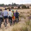 5 unicyclists head out for a ride on the Rim Loop Trail at Hidden Mesa Open Space.