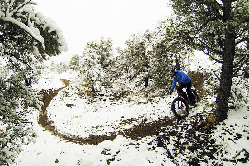 Swoopy singletrack snakes through a snowy Little Rainbow.