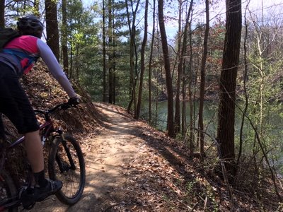 J. rounds a curve while enjoying the view of peaceful Stryker Lake on the East Lake Trail.