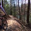 J. rounds a curve while enjoying the view of peaceful Stryker Lake on the East Lake Trail.