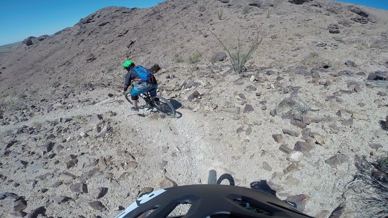 A rider goes foot out flat out heading down the switchbacks on Westside.
