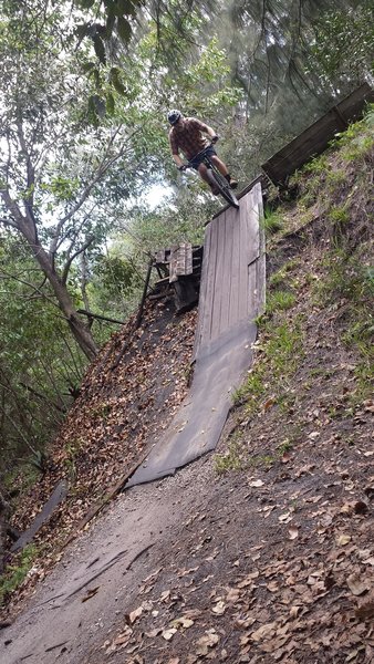 W. dropping into a wooden feature at the end of the Lost Ring Trail.