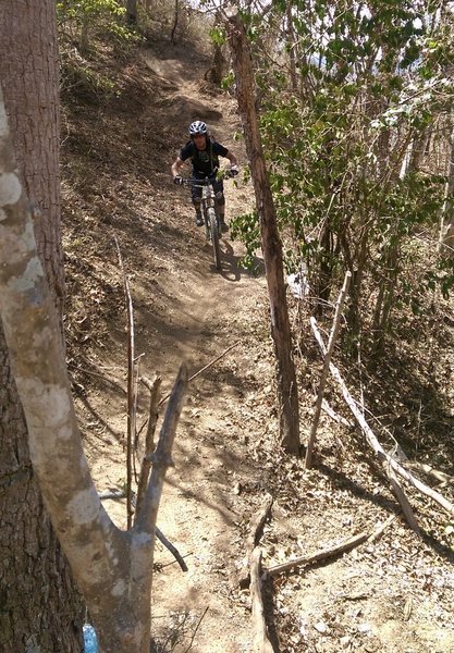 Chaz riding towards another steep descent.