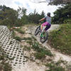 Julia pedals up a section of paver-stone berms and turf-block rollers. The SoFla builders find ingenious ways to vary the flat terrain.