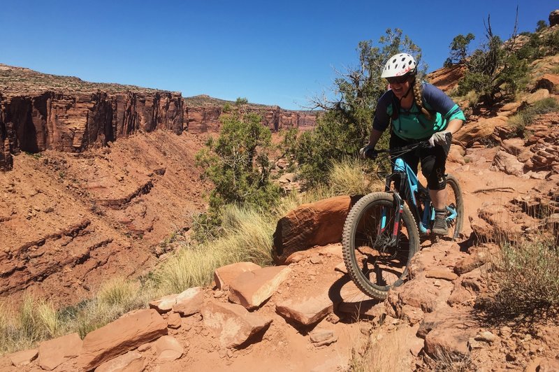 Ashley absolutely loves her new favorite trail as she descends toward the road on Porcupine Rim.