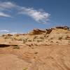 Stone formations rise above Lake Powell.