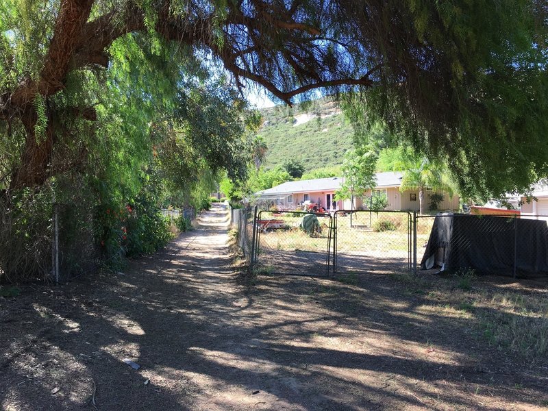 Cutting through an access trail between nearby homes towards the climb on the North trail.