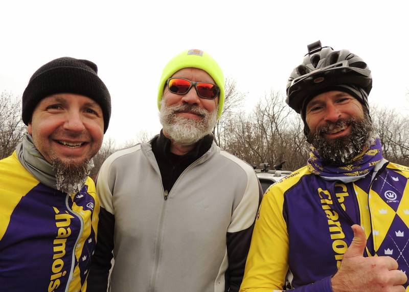 Three guys just riding bikes in the winter.