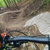 Riding into a wood and dirt coaster on the Green Loop.