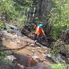 Heavy spring runoff adds to the adventure with several creek crossings. They're all rideable in spite of what this guy is doing.