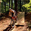 J. riding through wooden drop option on the Basic Training Skills Trail.